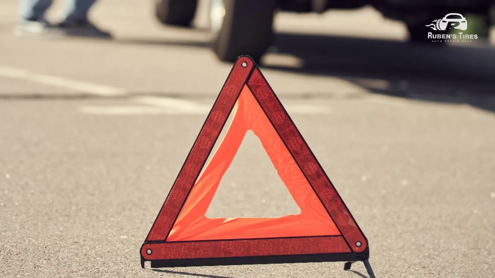 Emergency warning triangle on the road during a vehicle breakdown near Ruben's Tires in Apopka.