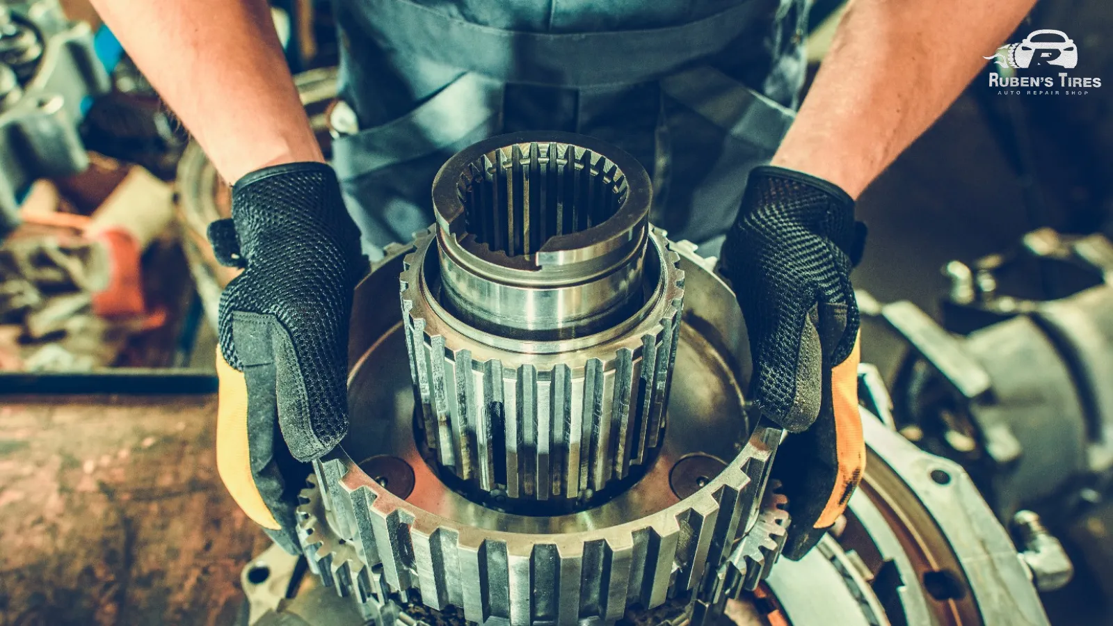 Mechanic handling transmission gears during repair at Ruben's Tires in Apopka.