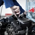 Technician using a screwdriver on a modern engine with diagnostic overlay, illustrating advanced and precise Engine Repair Apopka services at Ruben’s Tires.