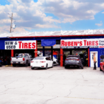 Exterior view of Ruben’s Tires location with multiple vehicles and clear signage for new and used tires, showcasing a trusted Tire Shop Apopka for quality service and products.